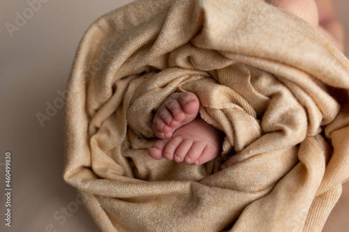 legs of a newborn baby on a beige background. baby feet © Svetlana
