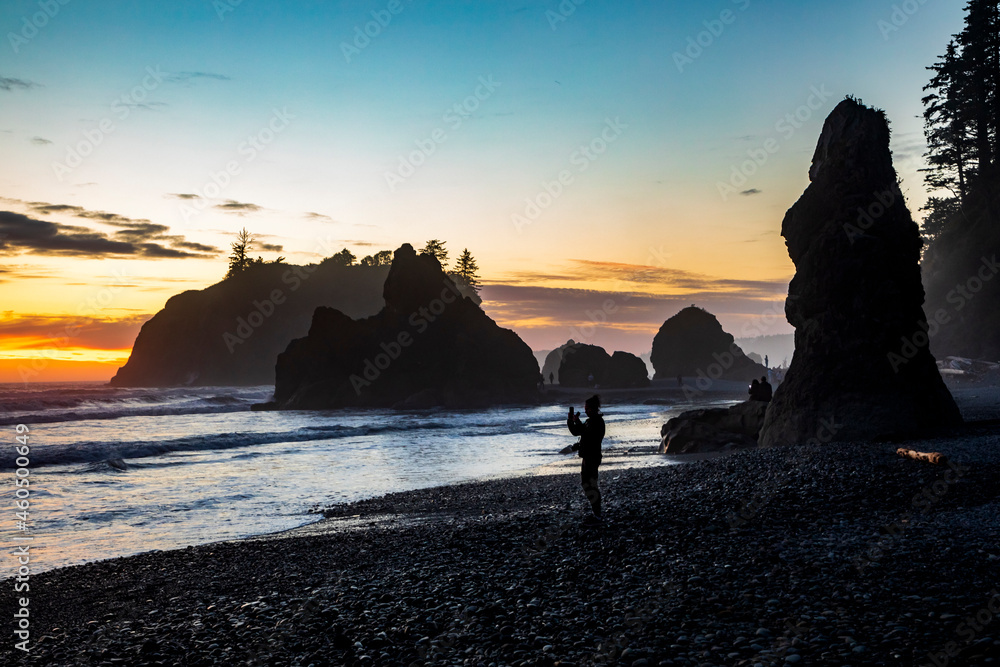 dramatic sunset in Ruby Beach with silhouette of sea stacks on the background in Olympic National Park in Washington state.