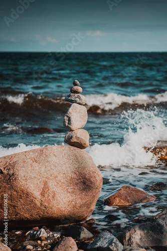 Zen stacked stones on the beach with blue ocean background and bright sunny happy summer vibes. Beautiful relaxed beach day. German Baltic Sea, Fehmarn,  Schleswig-Holstein, Northern Germany