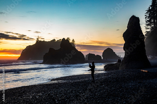 dramatic sunset in Ruby Beach with silhouette of sea stacks on the background in Olympic National Park in Washington state.