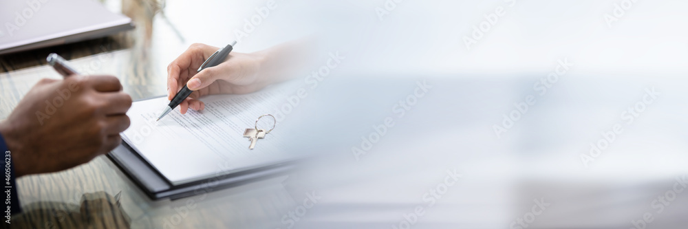 Businessman Signing Contract With Keys On It Businessman Signing Contract With Keys On It