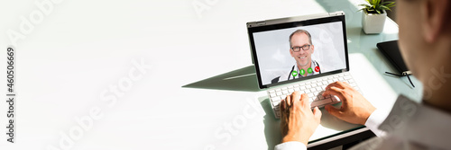 Businessman videoconferencing with doctor on laptop