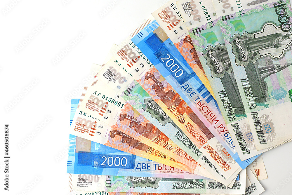 Russian rubles are fanned out on a white background. Currency exchange. Financial crisis, ruble devaluation concept. Selective focus. Top view, flat lay. Russian rubles are fanned out on a white background. Currency exchange. Financial crisis, ruble devaluation concept. Selective focus. Top view, flat lay.