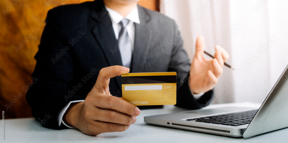businesswoman hand using smart phone, tablet payments and holding credit card online shopping, omni channel, digital tablet docking keyboard computer at office in sun light businesswoman hand using smart phone, tablet payments and holding credit card online shopping, omni channel, digital tablet docking keyboard computer at office in sun light