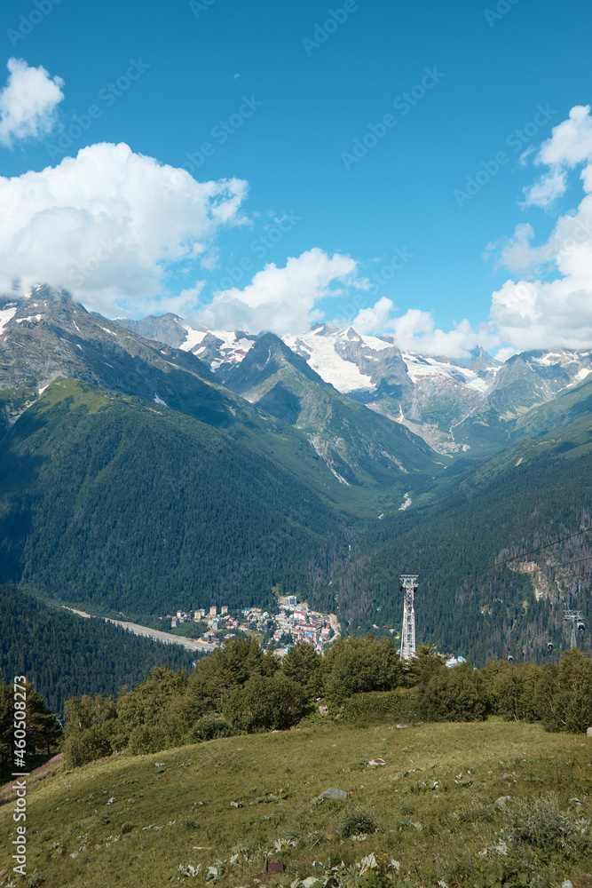 Landscape, mountain panorama, alpine meadows and mountain peaks in ice