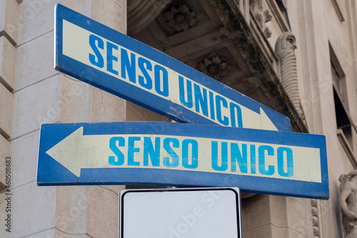 Road sign indicating one way (senso unico) in both directions