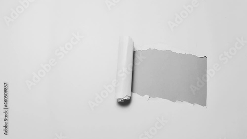 Stop motion photography concept. Diagonally torn paper in black and white.