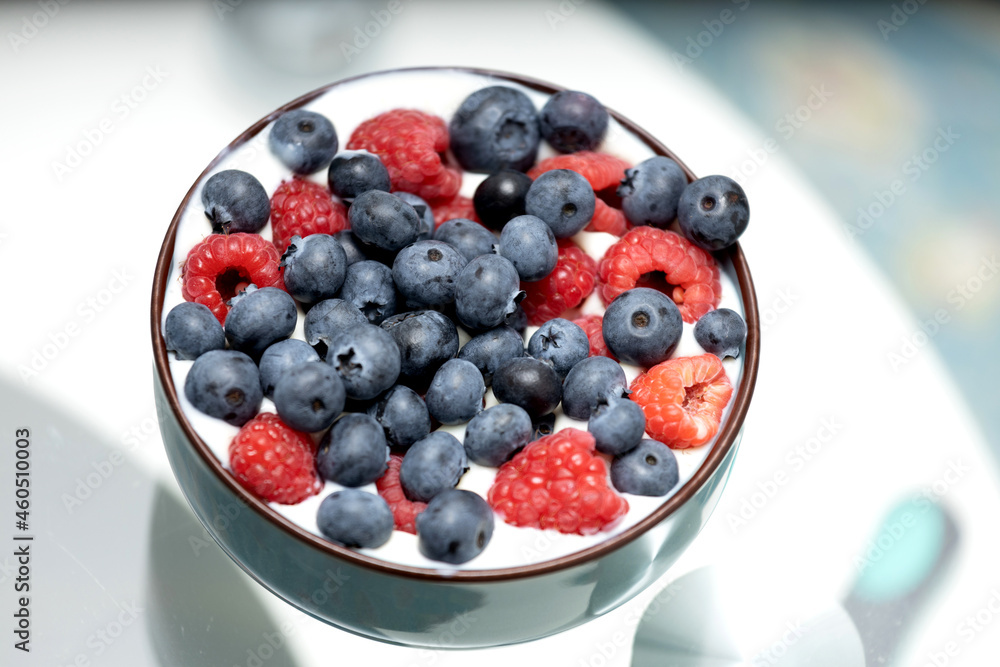 Raspberries and blueberries in a cup with yogurt. Raspberries and blueberries in a cup with yogurt.
