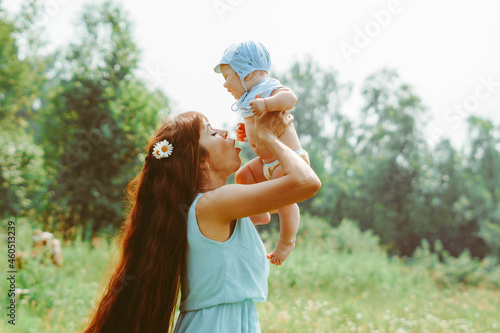 mother raises the child in her arms