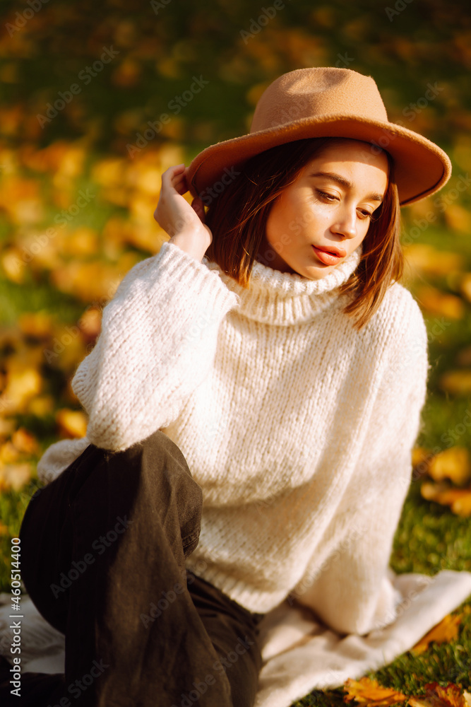 Young woman  resting in nature. Fashion, style concept. People, lifestyle, relaxation and vacations concept