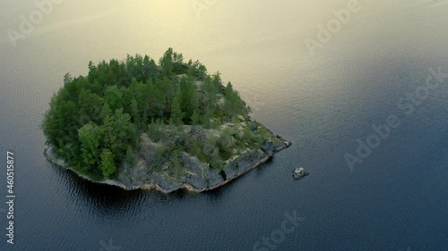 Aerial view of of small islands on a blue lake Saimaa. Landscape with drone. Blue lakes, islands and green forests from above on a cloudy summer morning. Lake landscape in Finland.	