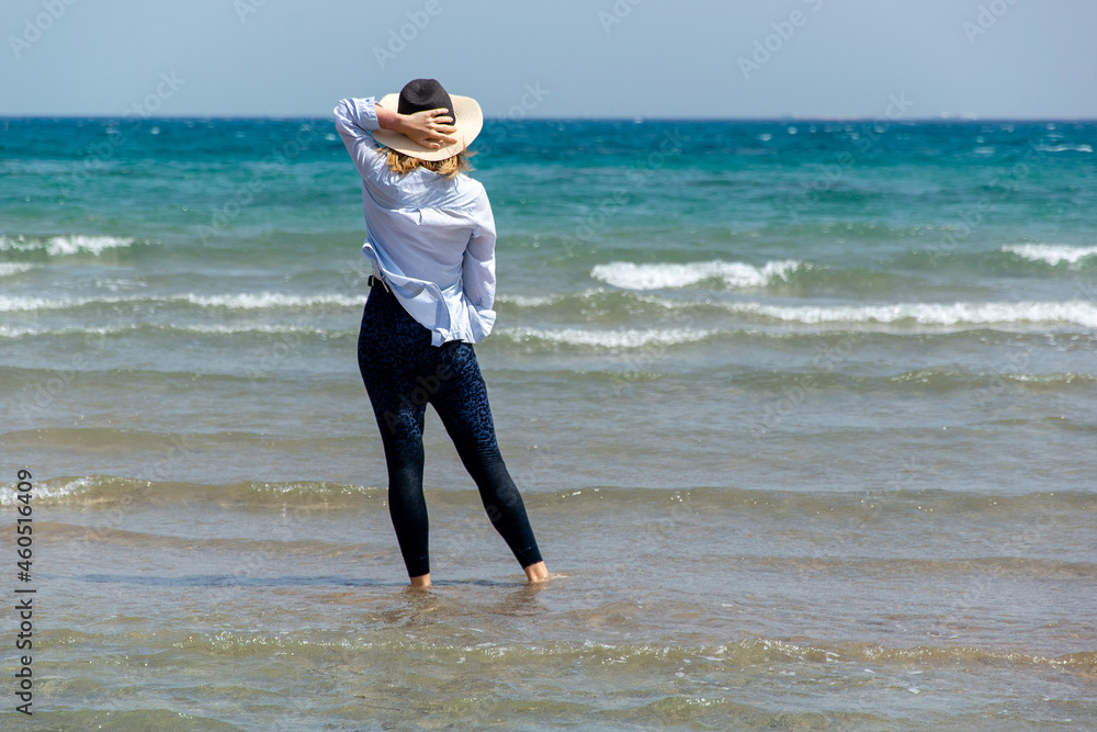 Cheerful tanned woman at beach enjoying nature-freedom. outdoor at tropical resort with her arms outstretched the wind. Beautiful young female enjoying day at ocean beach Cheerful tanned woman at beach enjoying nature-freedom. outdoor at tropical resort with her arms outstretched the wind. Beautiful young female enjoying day at ocean beach