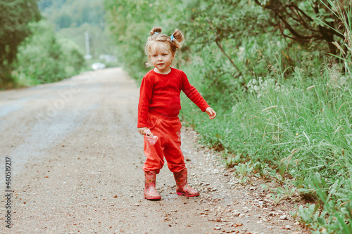 Fototapeta Naklejka Na Ścianę i Meble -  a child is walking along a country road