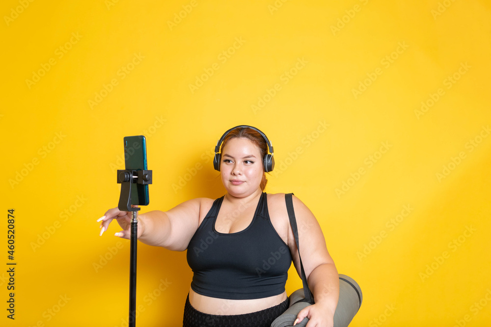 fat fitness woman starting online sports class on smartphone to lose weight fat fitness woman starting online sports class on smartphone to lose weight