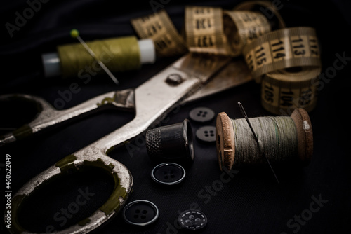 Sewing machine. Needle and thread. Thimble. Scissors. Sewing tools for fashion designers, designers, and seamstresses. Tailoring. © Vadzim