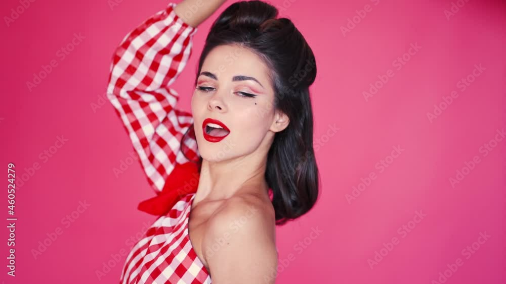 Young beautiful brunette in retro style pin-up is flirting Young beautiful brunette in retro style pin-up is flirting