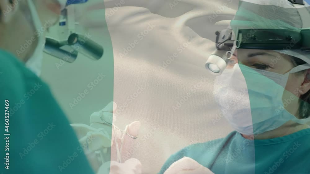 Animation of flag of italy waving over surgeons in operating theatre Animation of flag of italy waving over surgeons in operating theatre