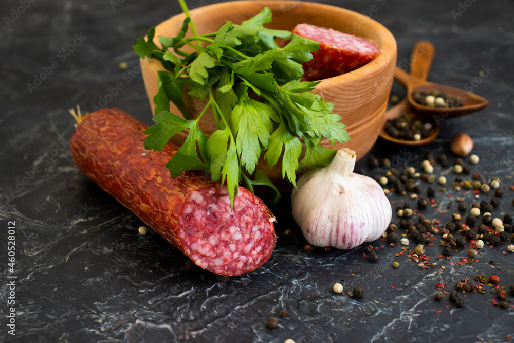sausage salami, spices on concrete background
sausage salami, spices on concrete background