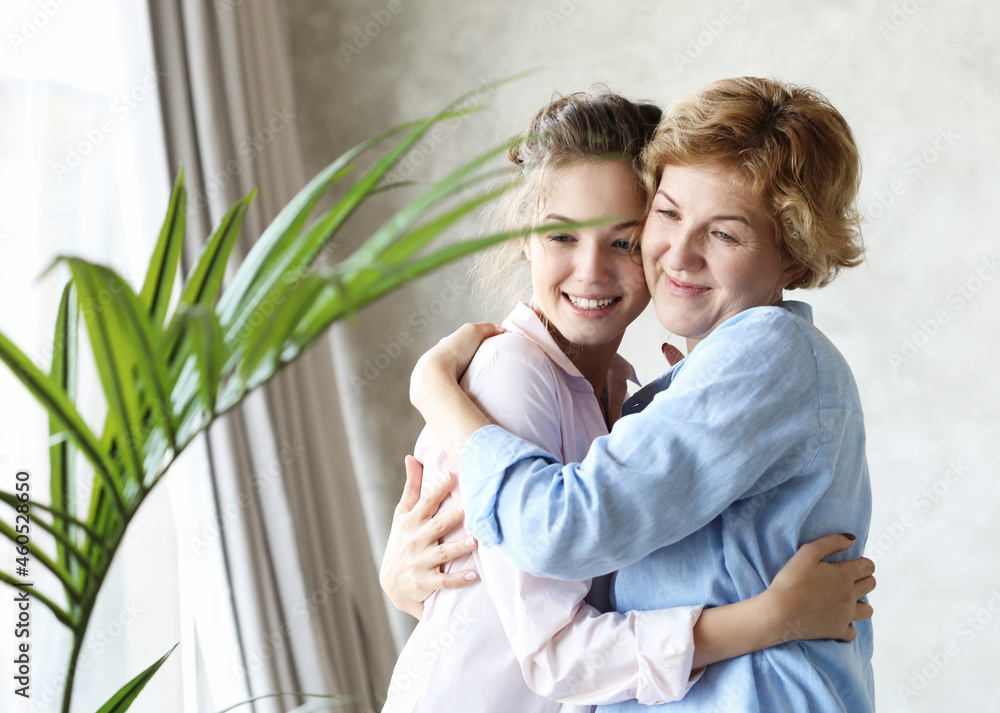lifestyle and people concept: Happy senior mother embracing adult daughter laughing together lifestyle and people concept: Happy senior mother embracing adult daughter laughing together