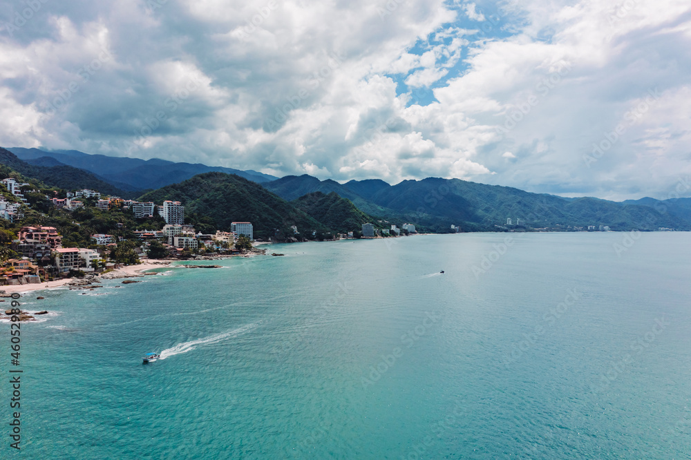 Drone View of the city of Puerto Vallarta beaches, port, and pier as well as the mountains