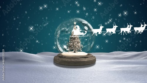 Santa claus in sleigh being pulled by reindeers against christmas tree in a snow globe photo