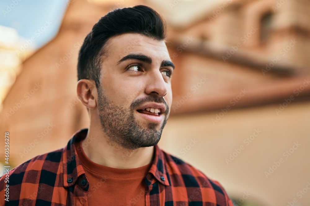 Young hispanic man smiling happy standing at the city. Young hispanic man smiling happy standing at the city.