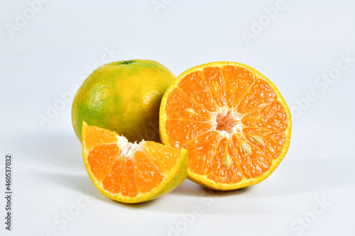 Half of orange and the whole orange. On white background.