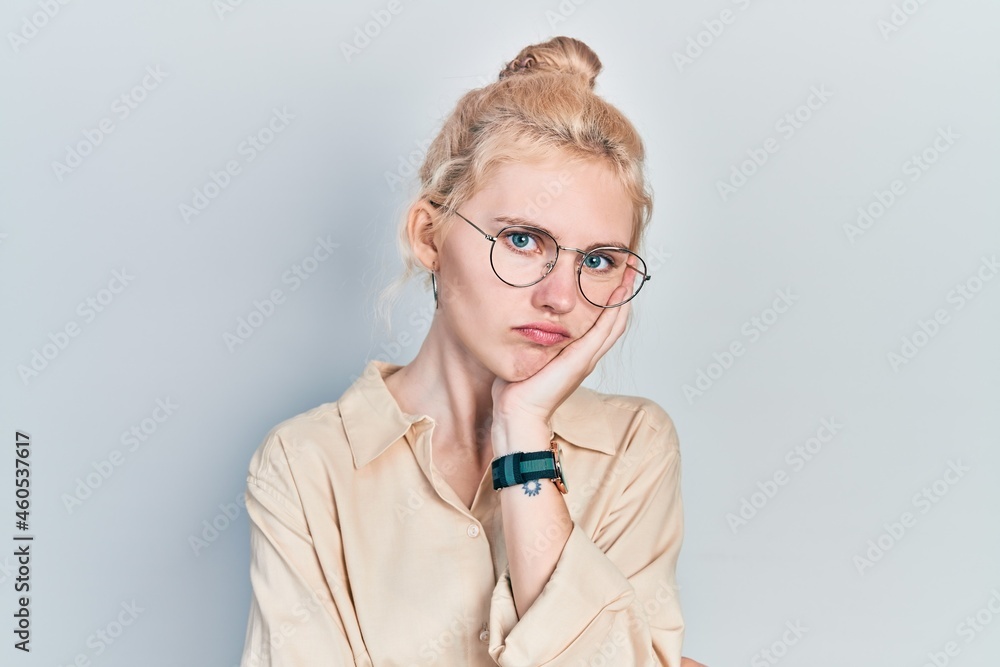 Beautiful caucasian woman with blond hair wearing casual look and glasses thinking looking tired and bored with depression problems with crossed arms.