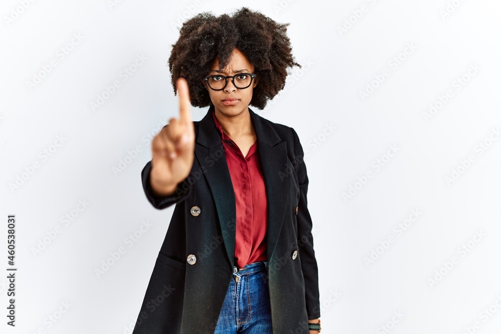 African american woman with afro hair wearing business jacket and glasses pointing with finger up and angry expression, showing no gesture African american woman with afro hair wearing business jacket and glasses pointing with finger up and angry expression, showing no gesture