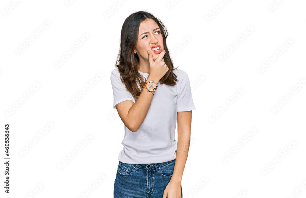 Young beautiful woman wearing casual white t shirt thinking worried about a question, concerned and nervous with hand on chin Young beautiful woman wearing casual white t shirt thinking worried about a question, concerned and nervous with hand on chin