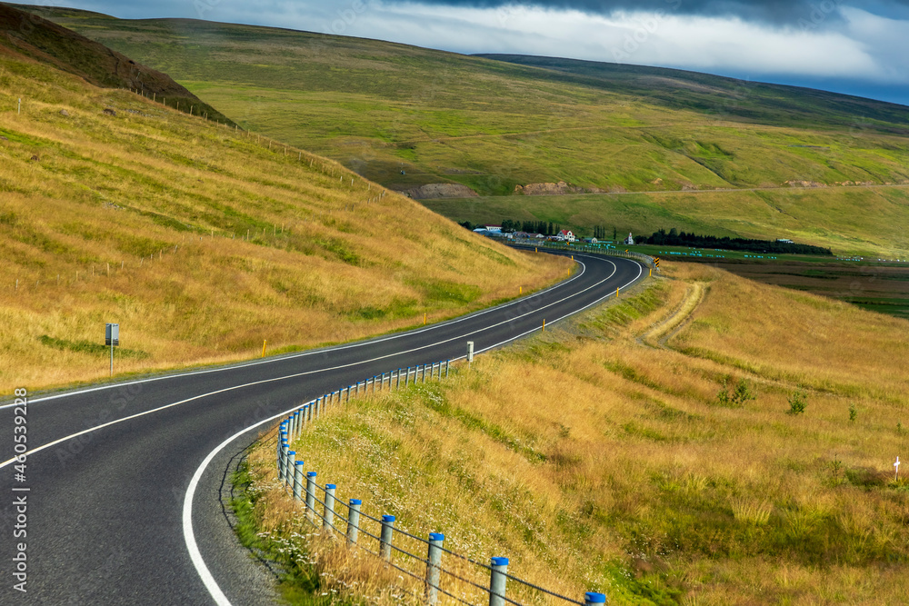 summer road trip on an open high way in Route 1 in Iceland with dramatic mountain landscape on the background. summer road trip on an open high way in Route 1 in Iceland with dramatic mountain landscape on the background.