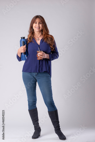 woman drinking mate, holding a termo