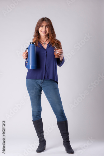woman drinking mate, holding a termo