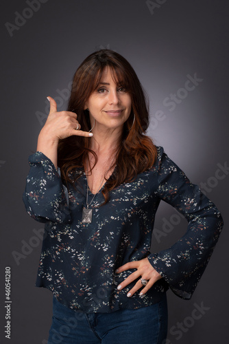 portrait of a woman, call me hand signal