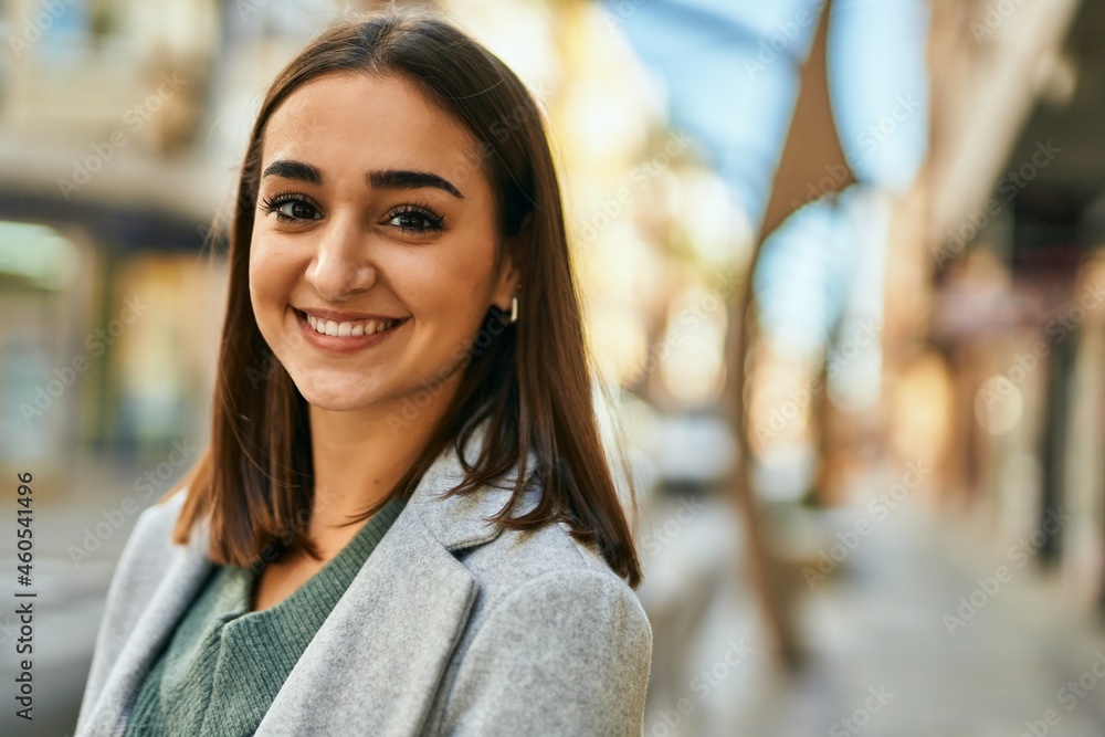 Young hispanic girl smiling happy standing at the city.