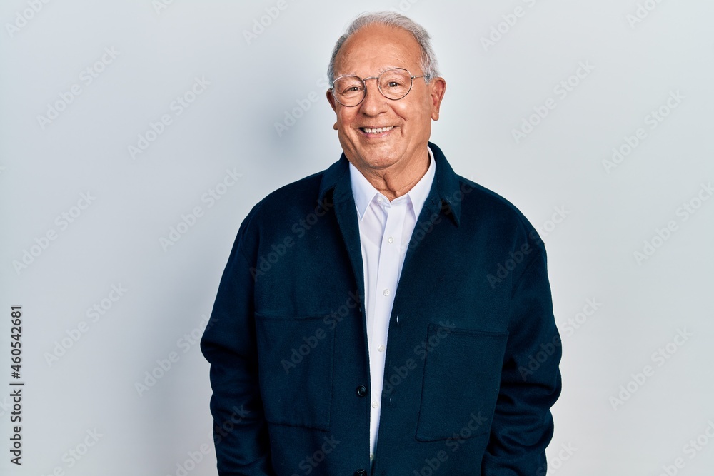 Senior man with grey hair wearing casual style and glasses relaxed with serious expression on face. simple and natural looking at the camera. Senior man with grey hair wearing casual style and glasses relaxed with serious expression on face. simple and natural looking at the camera.
