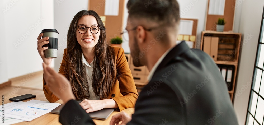 Two hispanic business workers smiling happy drinking coffee at the office. Two hispanic business workers smiling happy drinking coffee at the office.