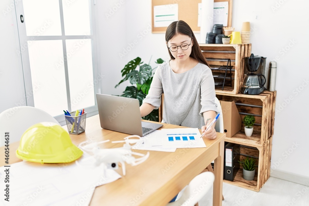 Young asian woman working with laptop at the office Young asian woman working with laptop at the office