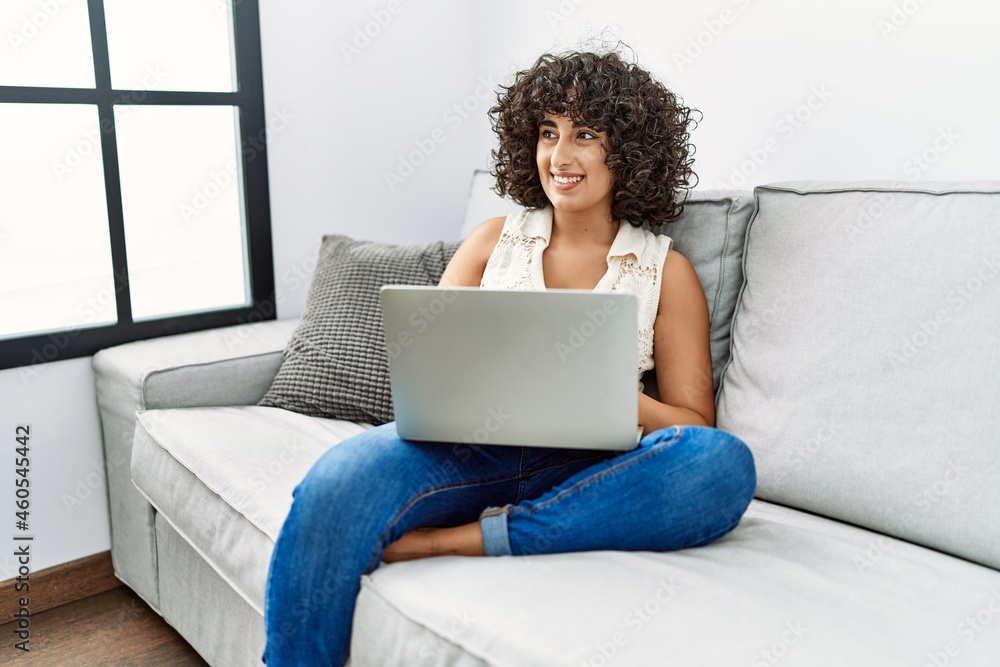 Young middle east woman smiling confident using laptop at home Young middle east woman smiling confident using laptop at home