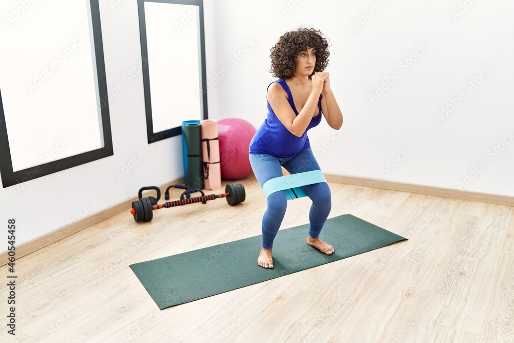 Young middle east woman training using elastic band at sport center Young middle east woman training using elastic band at sport center
