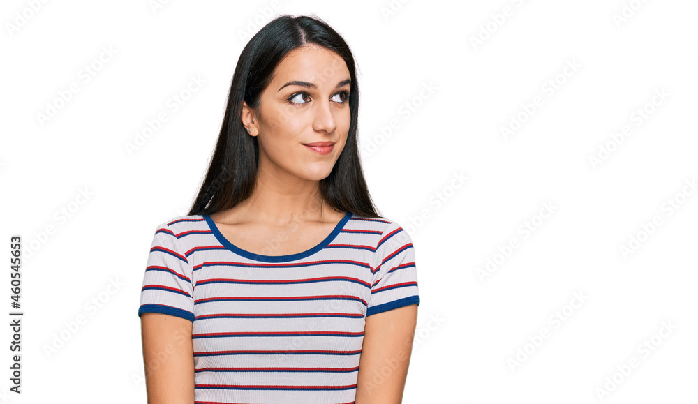 Young hispanic girl wearing casual striped t shirt smiling looking to the side and staring away thinking. Young hispanic girl wearing casual striped t shirt smiling looking to the side and staring away thinking.