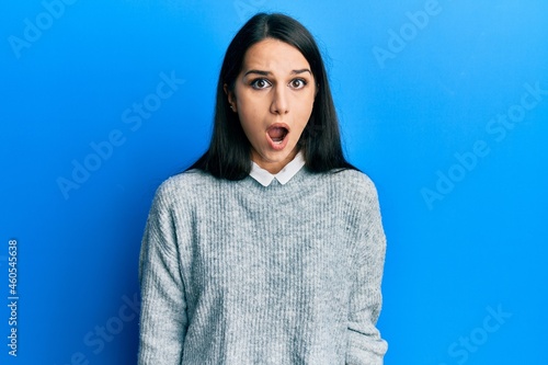 Young hispanic woman wearing casual clothes afraid and shocked with surprise and amazed expression, fear and excited face.