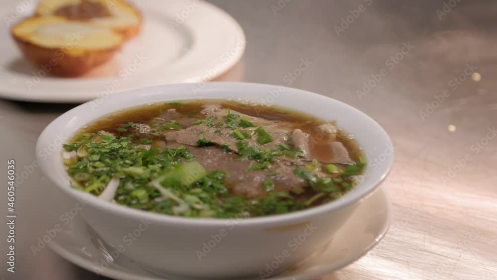 Restaurant kitchen pass, bowl of steaming pho, delicious soup. 4K 24FPS. Restaurant kitchen pass, bowl of steaming pho, delicious soup. 4K 24FPS.