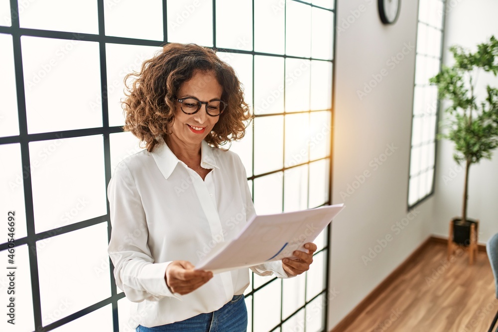 Middle age hispanic woman smiling confident working at office Middle age hispanic woman smiling confident working at office