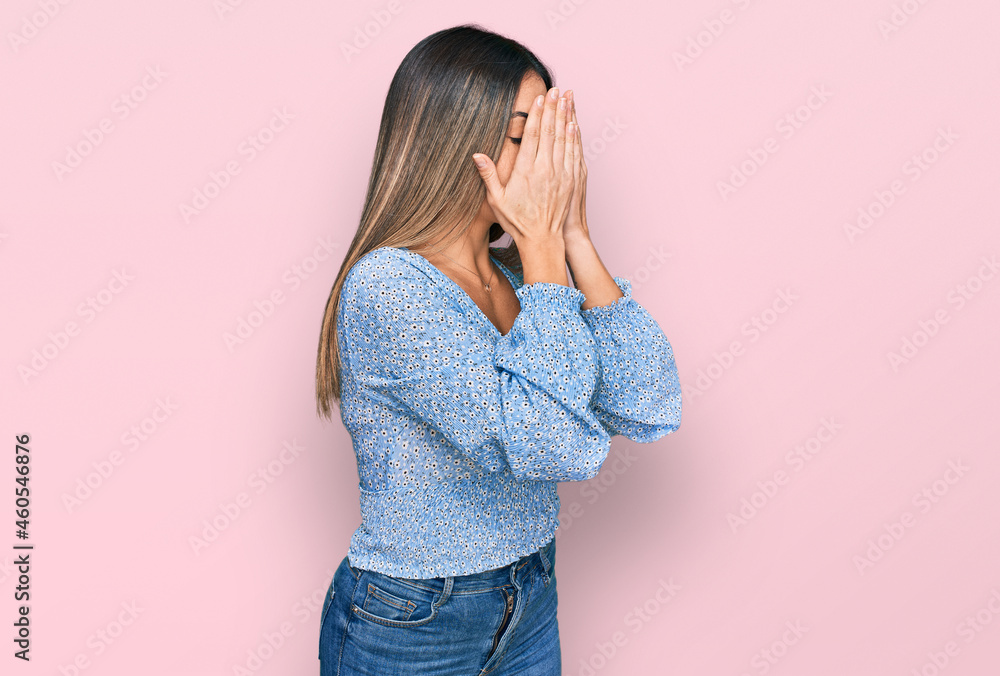 Young hispanic woman wearing casual clothes with sad expression covering face with hands while crying. depression concept. Young hispanic woman wearing casual clothes with sad expression covering face with hands while crying. depression concept.