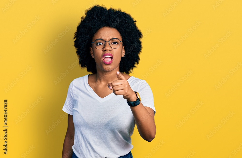 Young african american woman wearing casual white t shirt pointing displeased and frustrated to the camera, angry and furious with you
