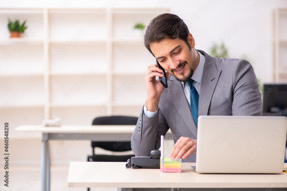 Young male employee working in the office Young male employee working in the office