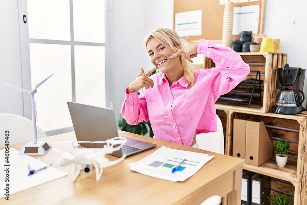 Young caucasian woman working at the office smiling cheerful showing and pointing with fingers teeth and mouth. dental health concept. Young caucasian woman working at the office smiling cheerful showing and pointing with fingers teeth and mouth. dental health concept.