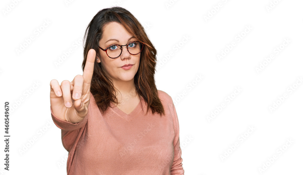 Young plus size woman wearing casual clothes and glasses pointing with finger up and angry expression, showing no gesture Young plus size woman wearing casual clothes and glasses pointing with finger up and angry expression, showing no gesture