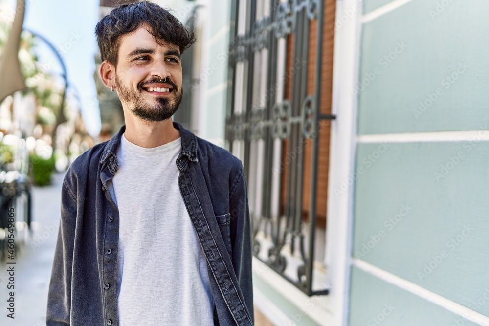 Young hispanic man smiling happy standing at the city. Young hispanic man smiling happy standing at the city.